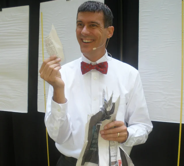 A torn up newspaper, magic, and storytelling demonstrate where money goes...and how little remains after essentials are paid for.