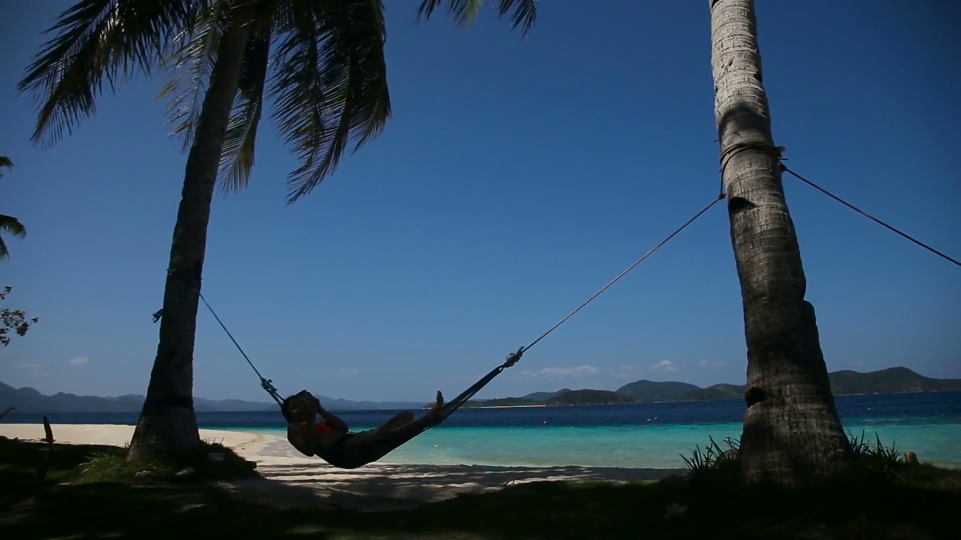 silhouette-of-man-in-hammock-on-the-beachidyllic-beach-with-coconut-trees-and-hammocktravel-concept_eimbsrb9g__F0000.png