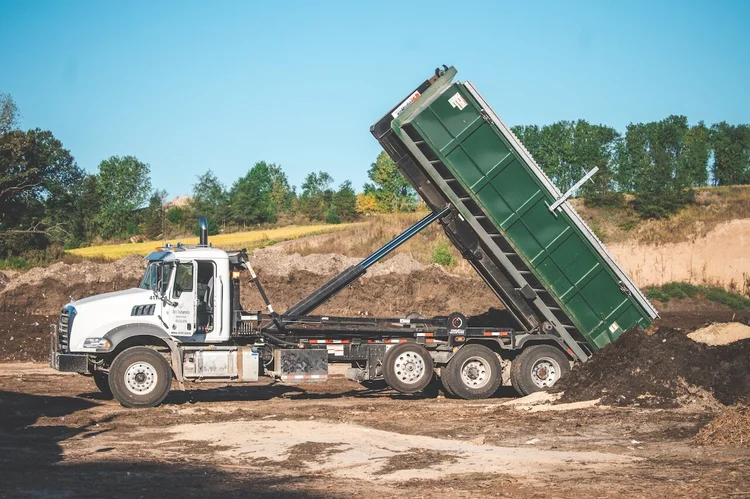 Roll-off truck tipping a load at the Soil Dynamics yard