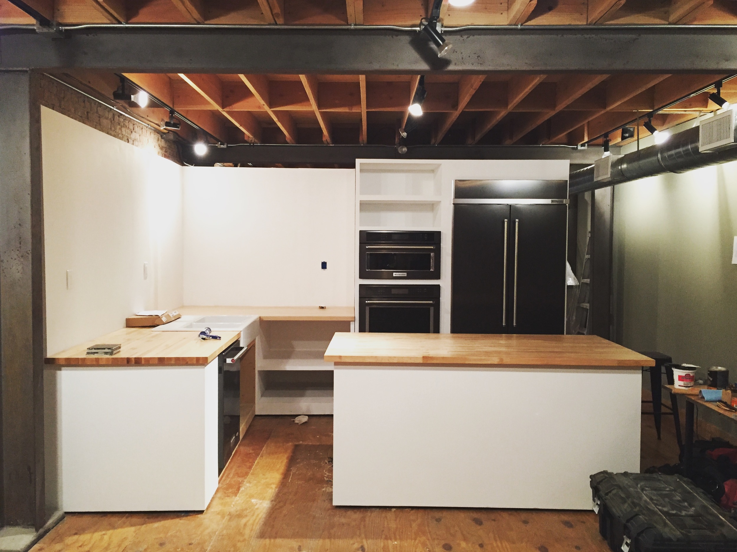 Day Four: 1 1/2" hard maple tops cut, glued up and placed, sink and appliances installed, paint applied.