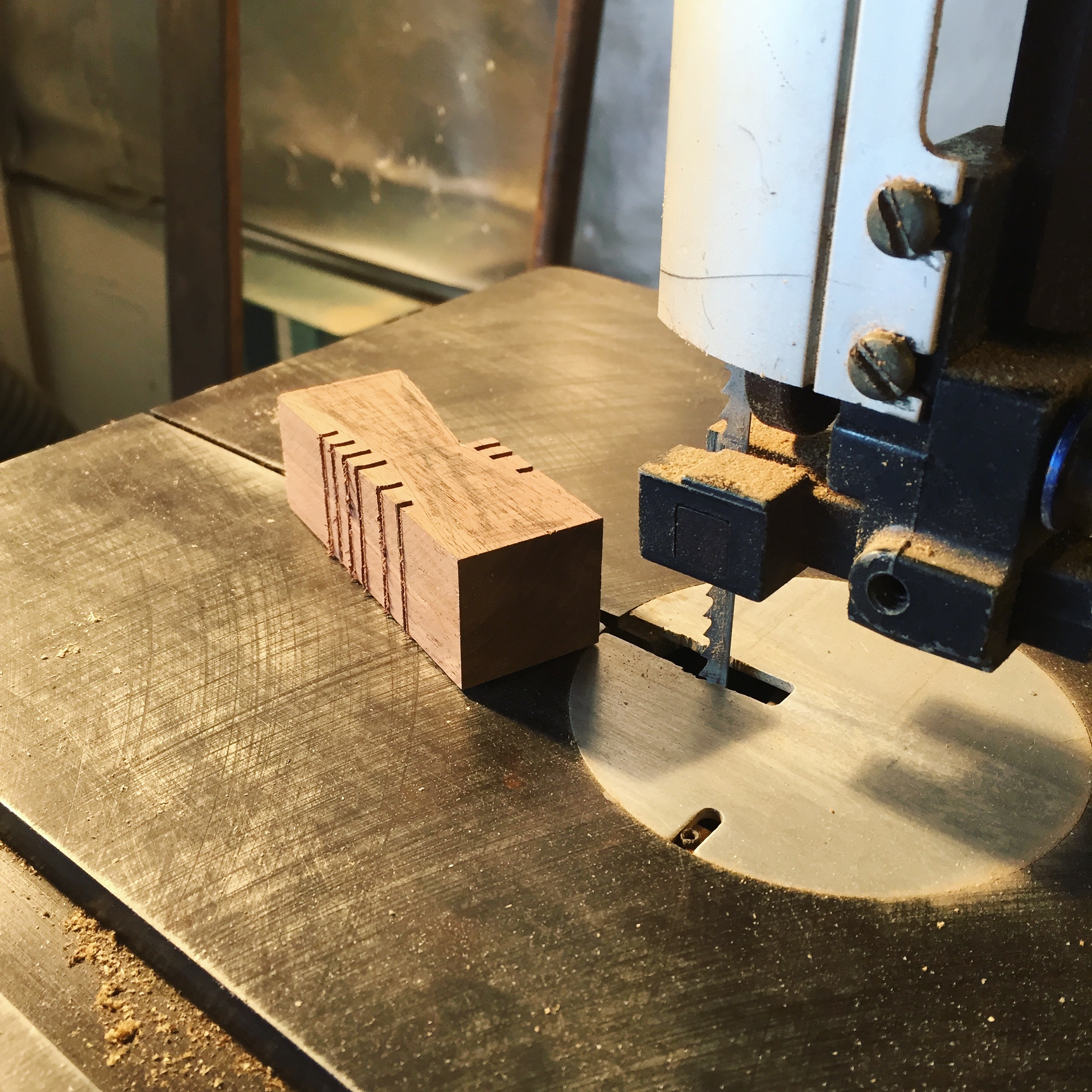 Walnut cookies being cut on the band saw.