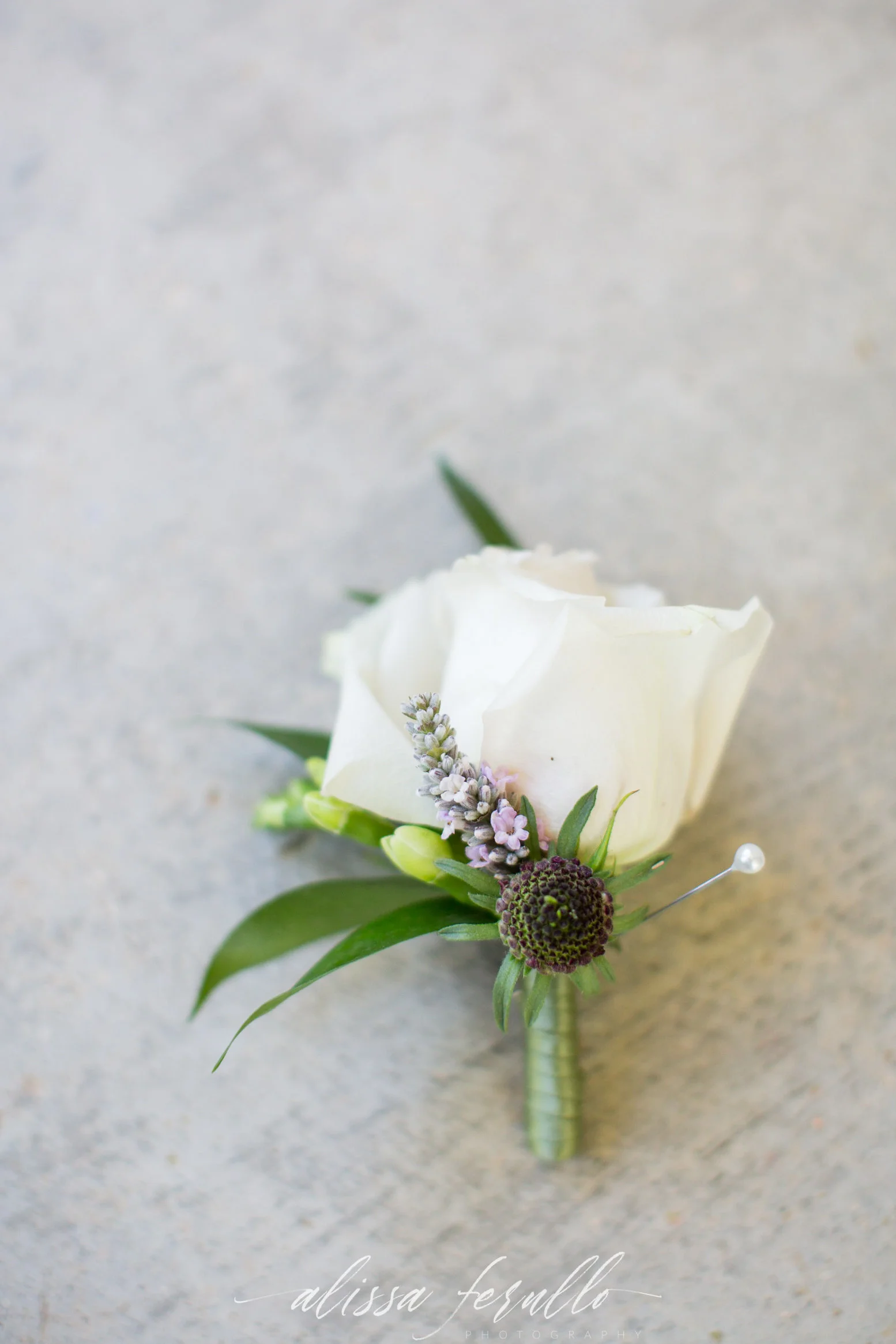 Captured by Alissa Ferullo Photography White rose and lavender boutonniere for a Wyoming destination wedding.