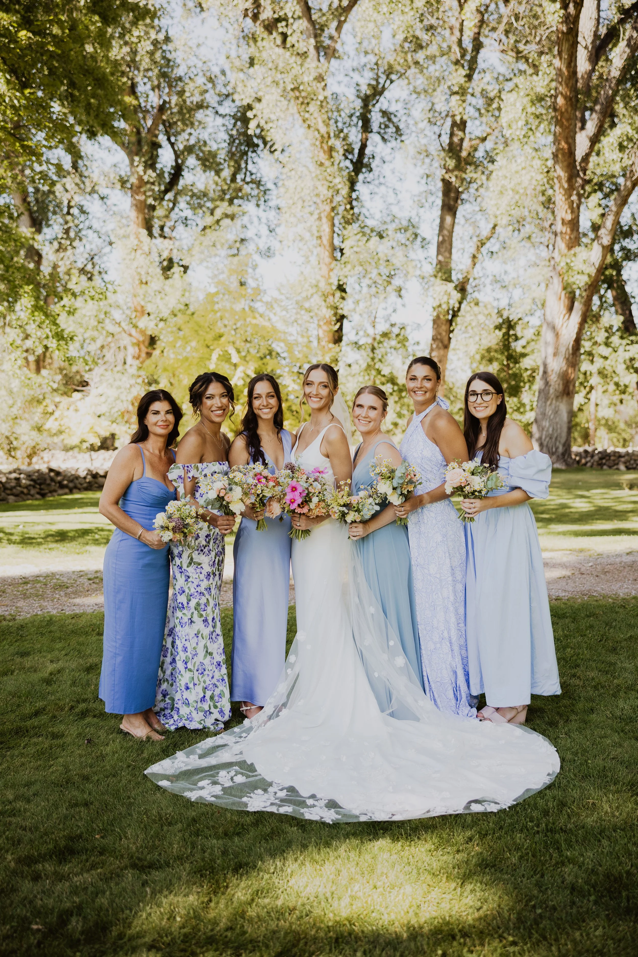 A wildflower wedding in blue with mixed bridesmaid dresses. Wyoming wedding venue The brinton museum. wedding flowers by sheridan wy florist whirly girl flowers