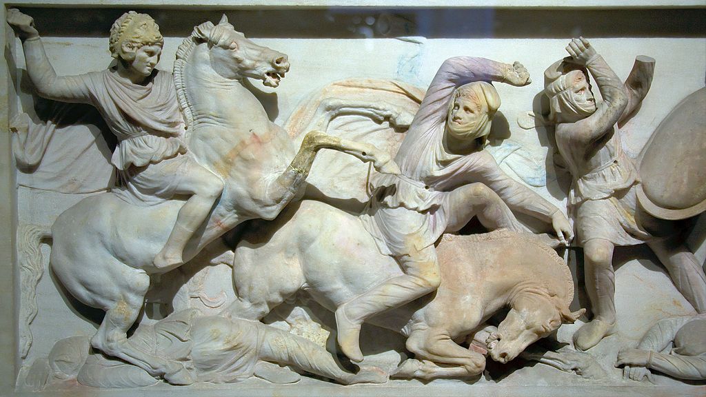 A portion of the Alexander Sarcophagus (late 4th century BCE) shows Alexander wearing a lion head helmet at the Battle of Issus.