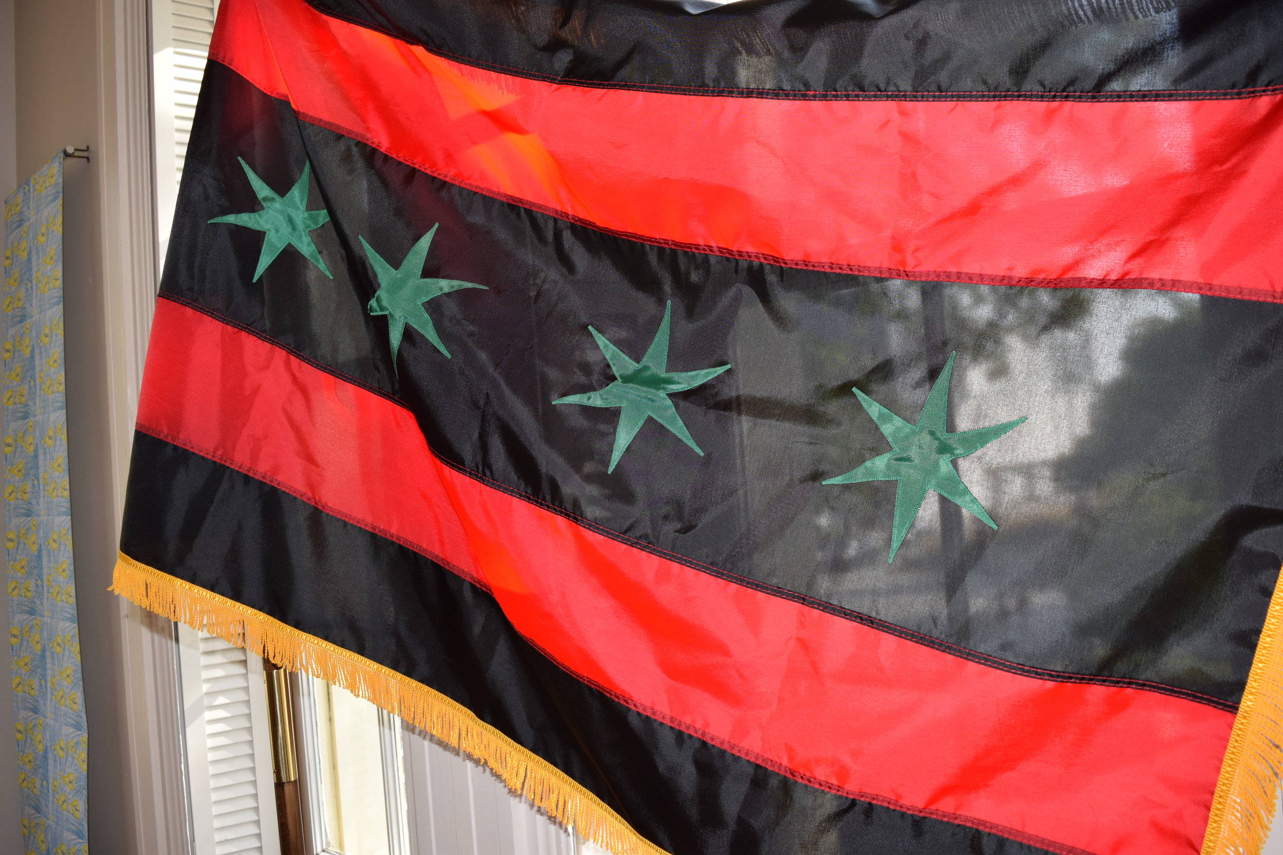   360 Nation  reimagines the Chicago state flag in red, black and green with gold fringe, the colors of the organization. 