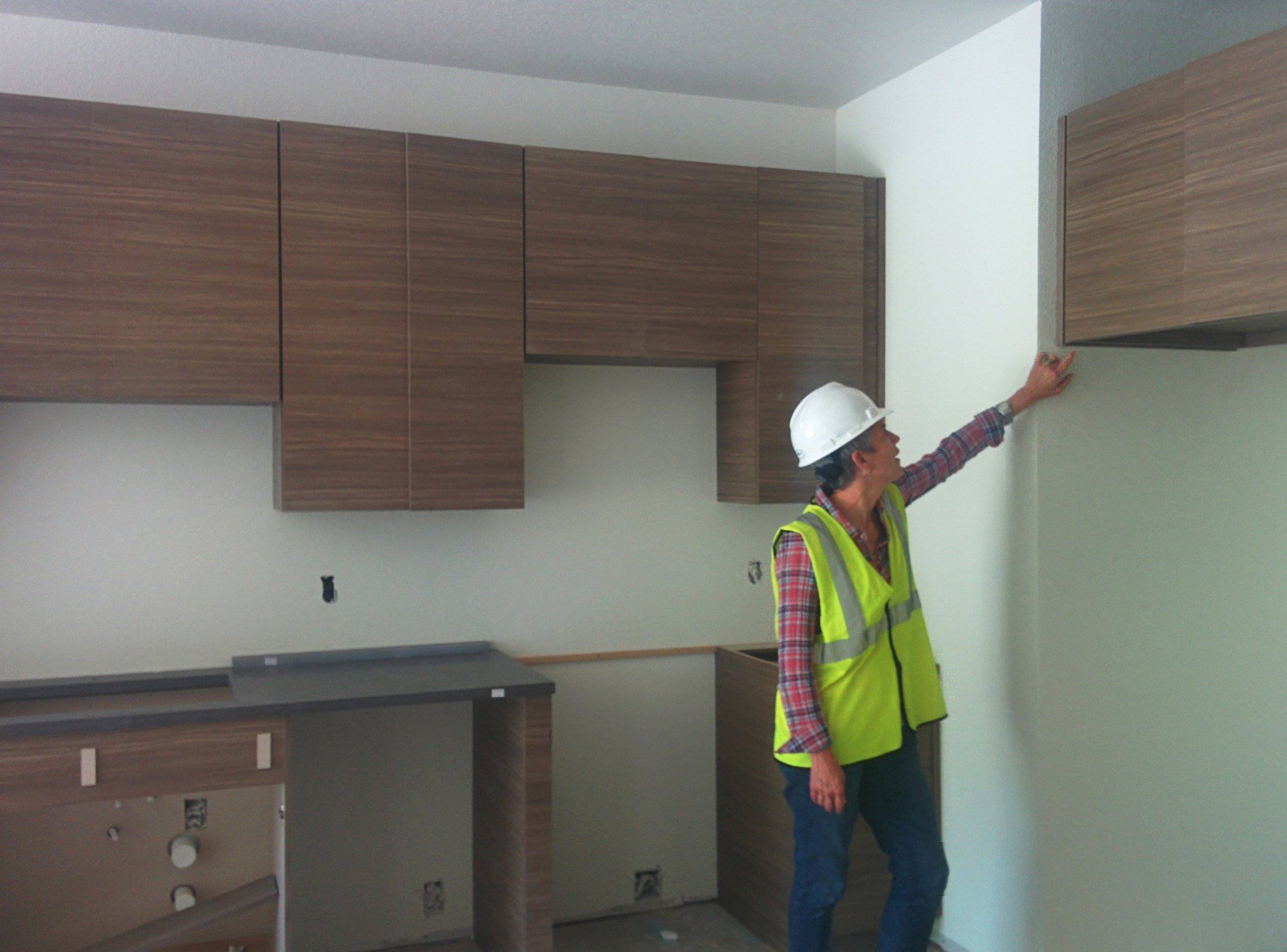 Kathy inspecting cabinetry at Unit.jpg