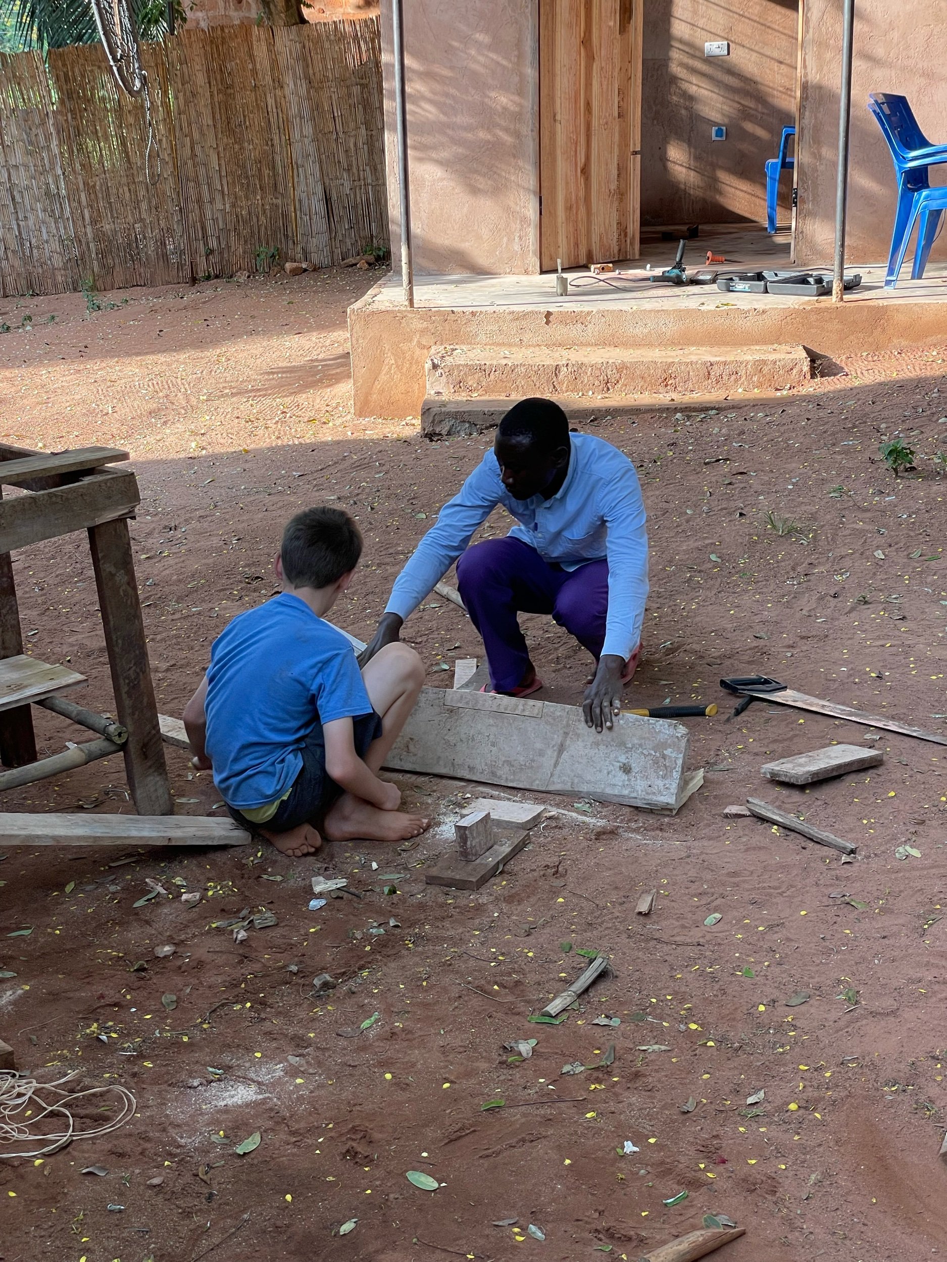 Judah and Musa working together to build a table.