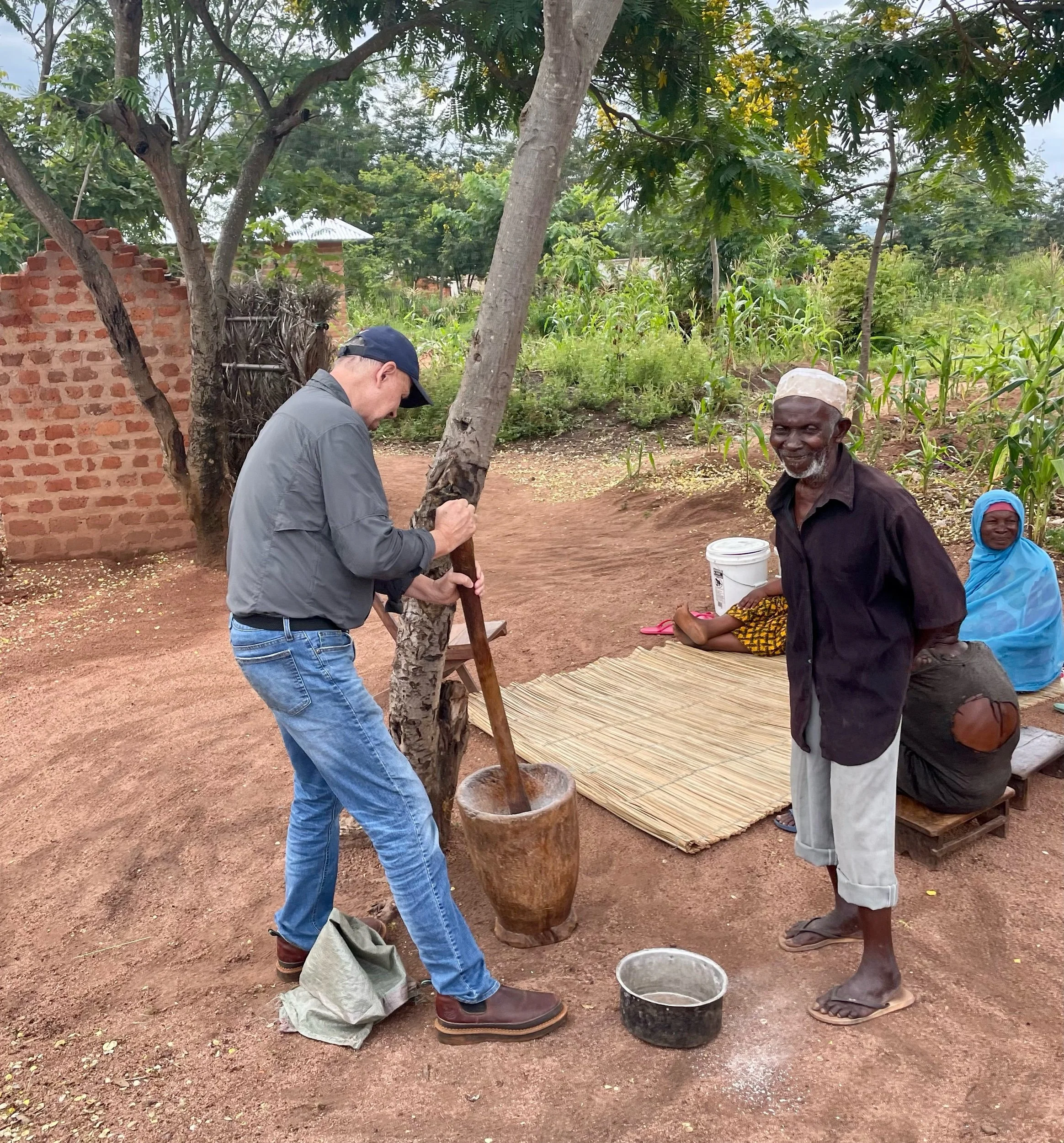 Mihigo(Kelly) tries his hand at grinding cassava.