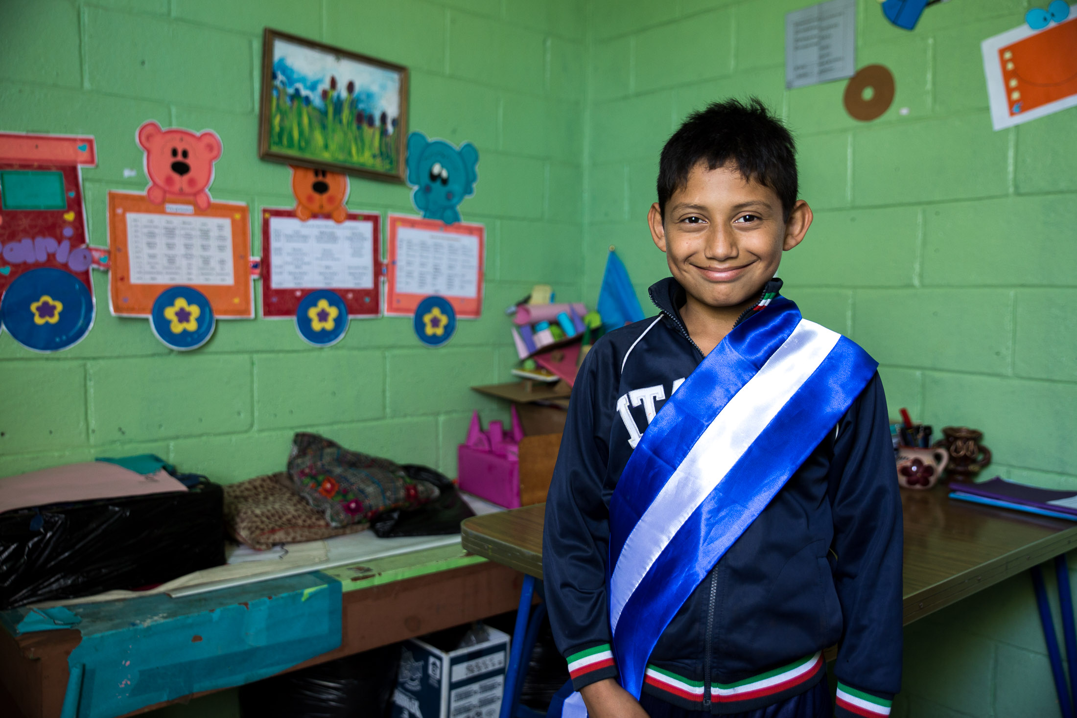The sash signifies that David is the top student at Amigos de Jesus school