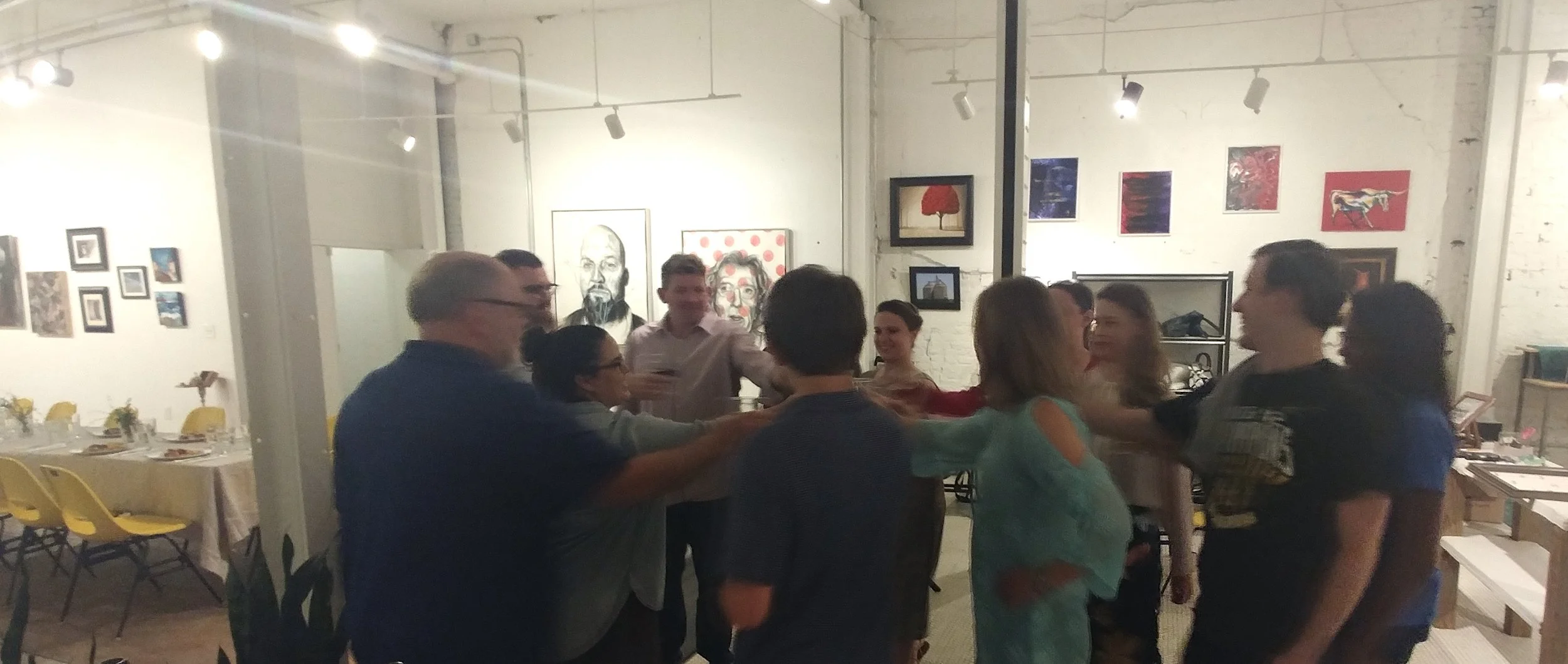 Staff, artists, and volunteers at Cultivate 7twelve toasting to success