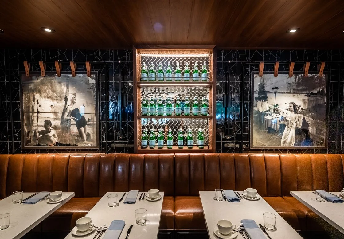 Italy’s go-to table water San Pellegrino doubles as glowing green wall decor, alongside retro images of women posing along scenic shores.