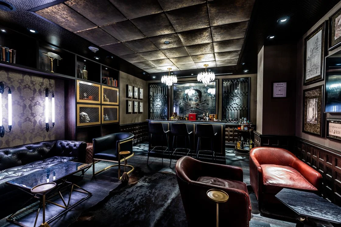 Seductive details at Society include dark distressed leather, gothic-style candlestick wall sconces, and diamond glass chandeliers.