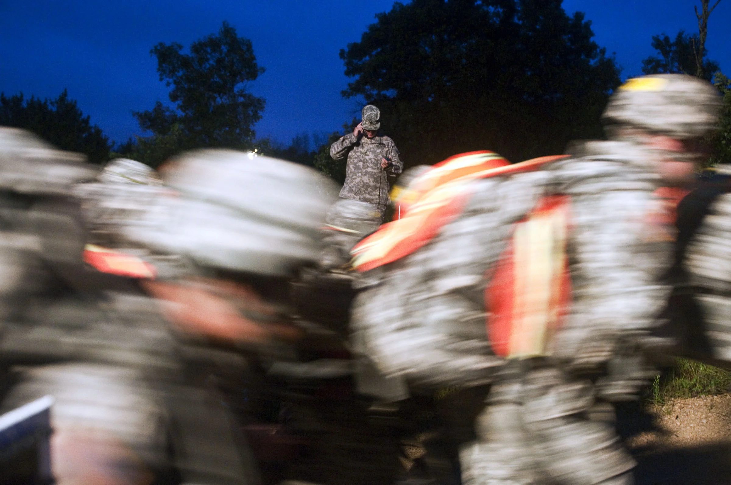  An official starts the timer and calls the finish line to synch their watches as competitors for the 2010 Army Reserve Best Warrior Competition sprint out to start the 10-kilometer ruck march before dawn on Fort McCoy, Wis., July 28, 2010. (U.S. Arm