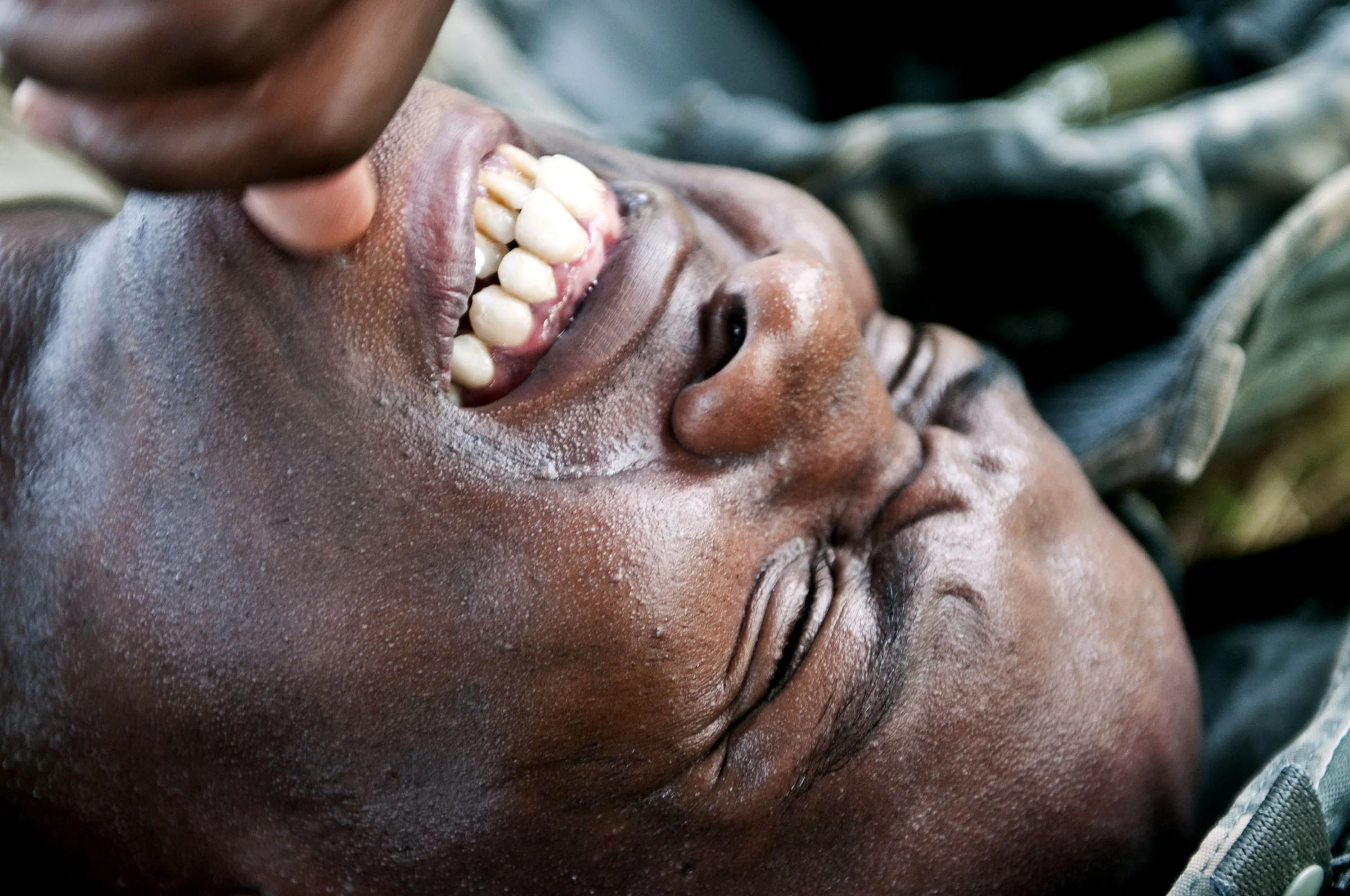  Staff Sgt. Jason E. Searcy, a military policeman from Columbus, Ga., assigned to the 75th Division, grits his teeth while getting an intravenous injection to replenish vital fluid after completing a 10-kilometer ruck march for the 2010 Army Reserve 