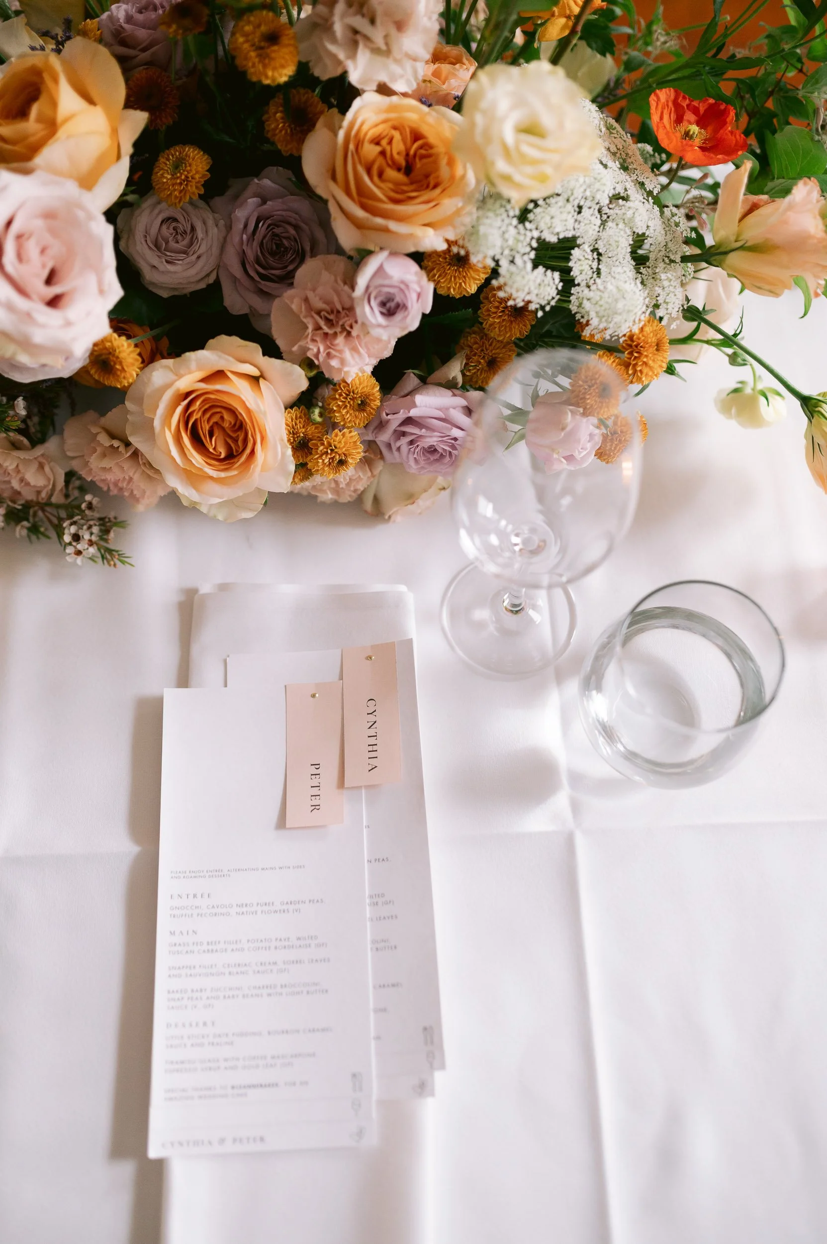 Table setting with floral centerpiece and menu cards