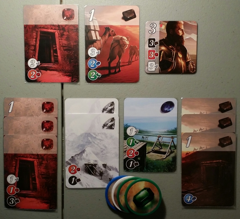 In the example above, because the player has 3 Ruby Development cards and 2 Diamond Development cards collected, they could the Ruby card featured above for free. Or they could buy the Onyx Development card with only having to spend 1 Diamond, 1 Sapphire, and 2 Emerald tokens. If this player manages to buy another Diamond Development card, at the end of that turn they would meet the requirements to lure the featured Noble to their shop!