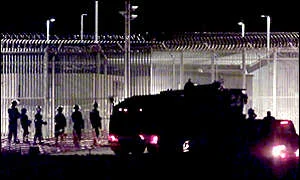 Woomera, water cannon and guards near perimeter fence used in 2001 - I was there during the few days this 'incident' occurred, watching the women and children among the groups of people being pushed by the full force of the water cannon, with all the other protesters (and so-called 'refugee people') who had travelled from Australia's major cities and regional areas.