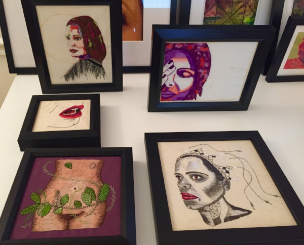 Various pieces of my artwork framed, on my dining table.