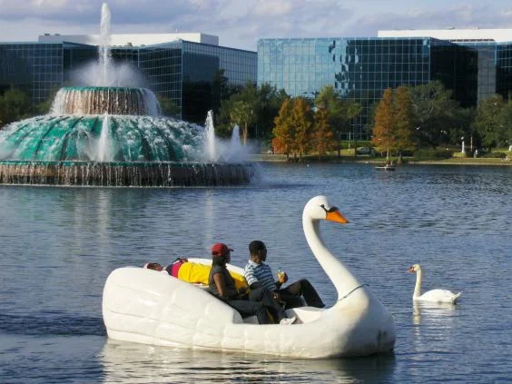 Visitors to Lake Eola pedal a swan boat past the fountain where 36-year-old Kyle Thurston was stranded after taking MDMA (Joe Shlabotnik/Creative Commons)