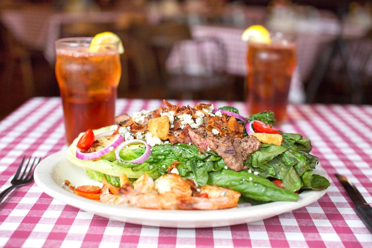 Our Father's Day Salad with steak and grilled shrimp on a romaine salad wedge.