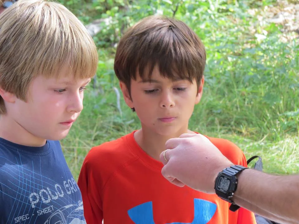 Showing some young birders a hummingbird up close.