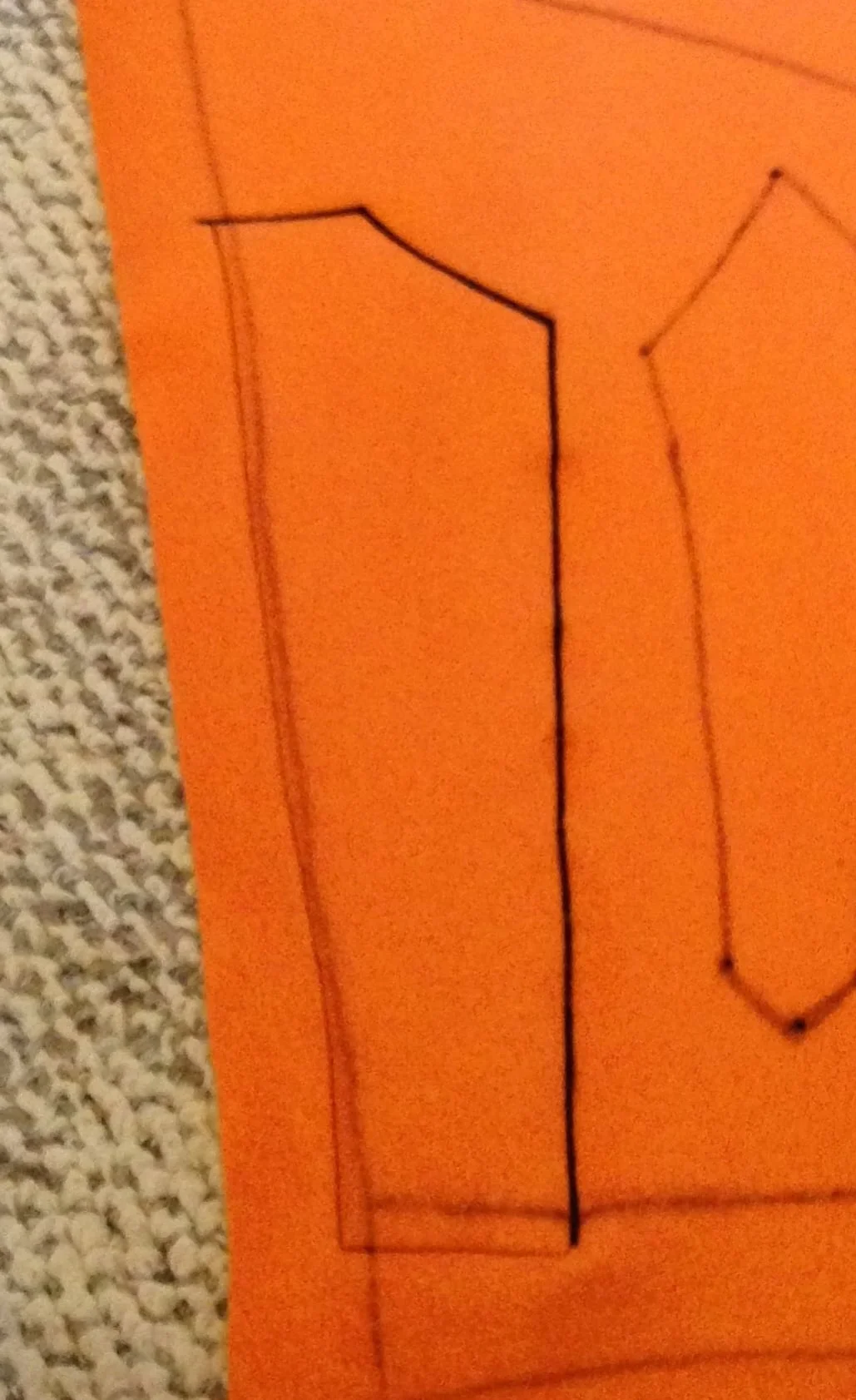  Here you can see the bold line of stitching (sorry it's not super in focus). You'll also notice that when a design goes "off the edge" that is to say, it ends on a seam, you'll want to carry your stitches over the edge line and you can just use a longer straight stitch so you won't use up quite as much time and thread.