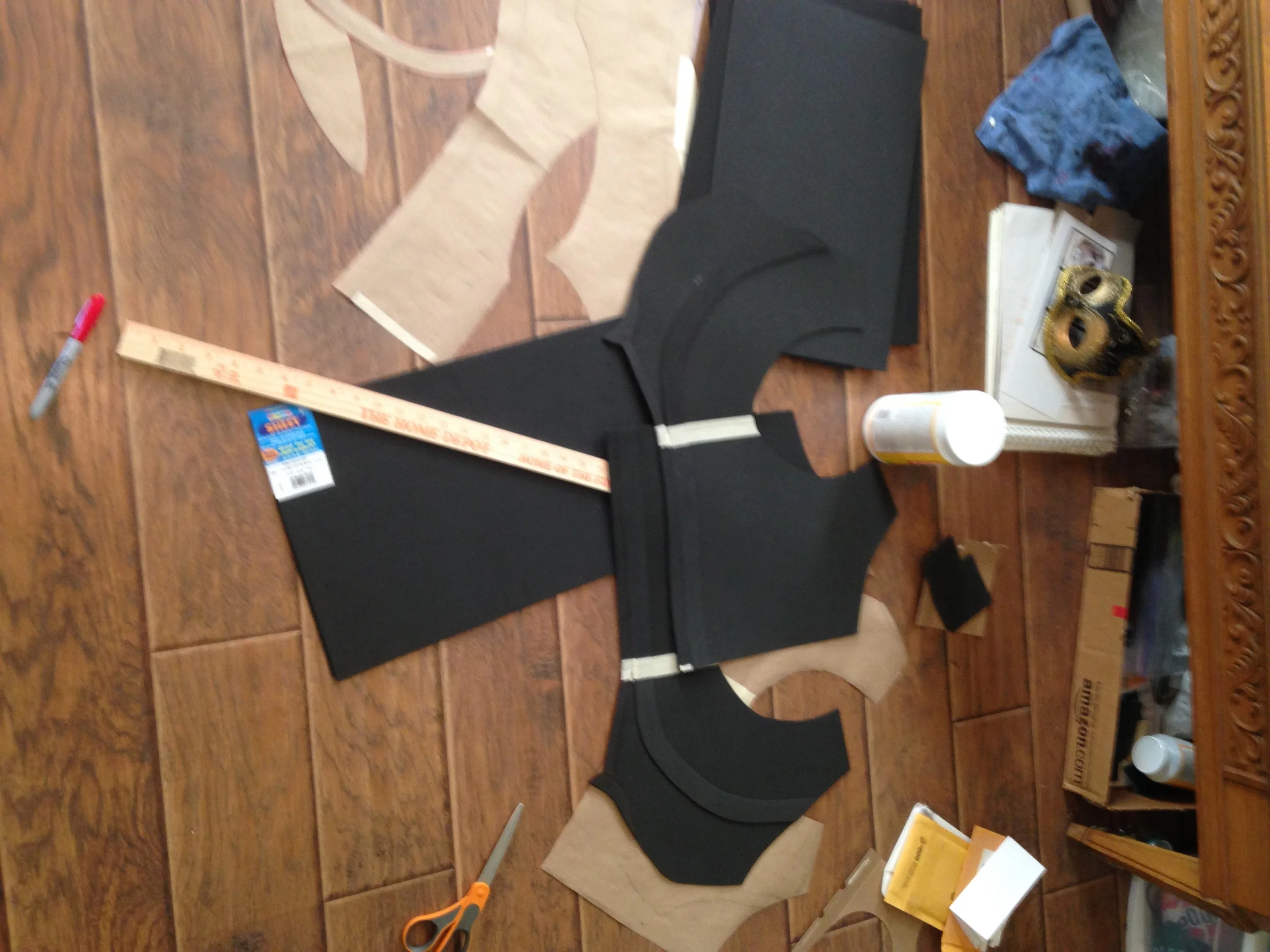 The base layer for most of the pieces is done in foamies, though there are some pieces that have a base layer made from cardstock or compressed paperboard. Generally when I needed a more intricate shape with specific angles, the cardstock was better than the foam because t remained stiff even when the heated worbla got wobbly. Craft foam on the other hand does not keep its structural integrity when heated up, so there are a few wonky spots in the breastplate. Thankfully with everything being black they're not terribly noticable and most of them should be covered by his capelet anyway,
