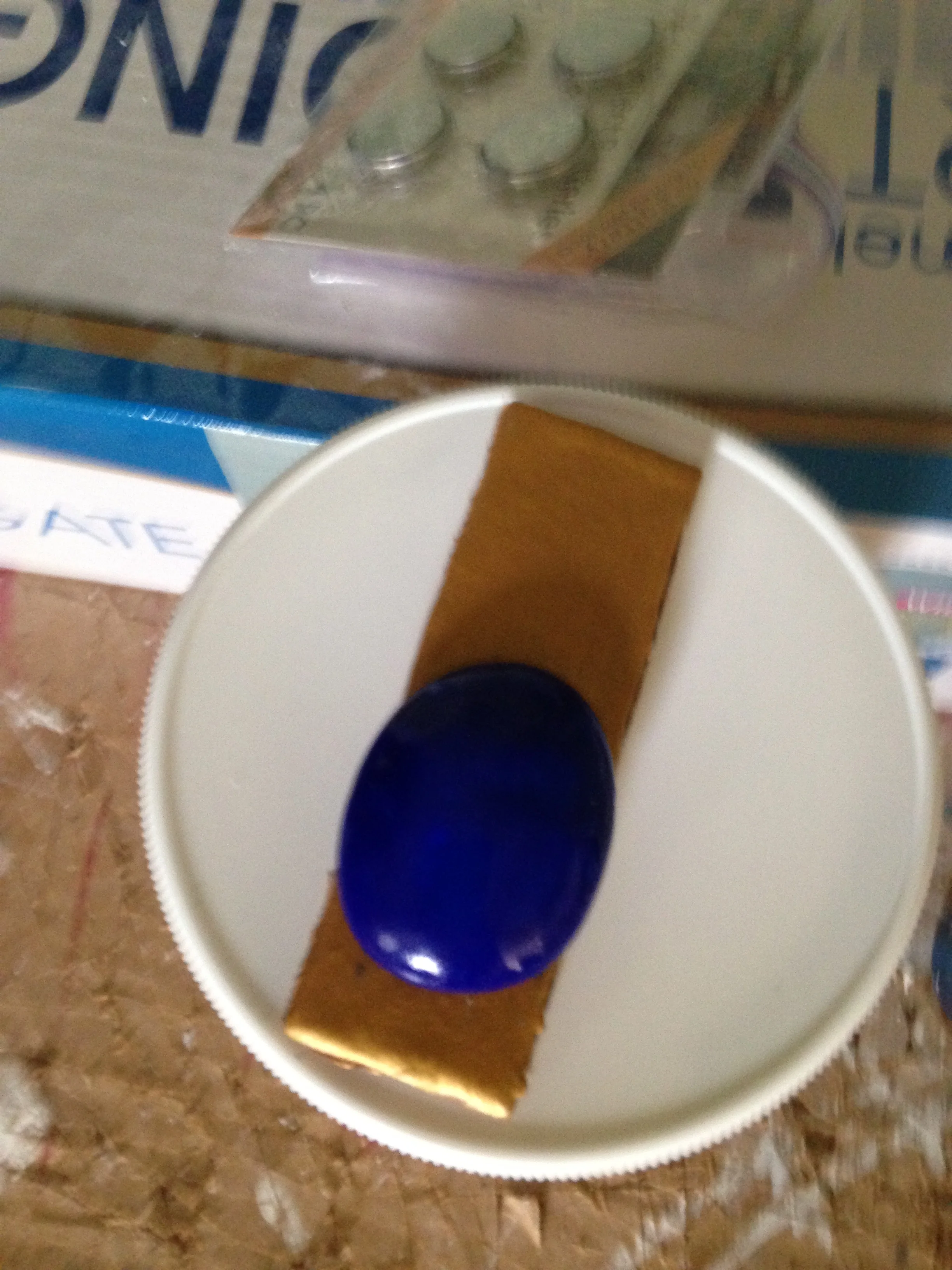 Here's the gem, it's just blue sculpey, but I did use the sharpie on it as well to give it the same tone as the crystal, then I sprayed it with the shellac to make it nice and shiny!