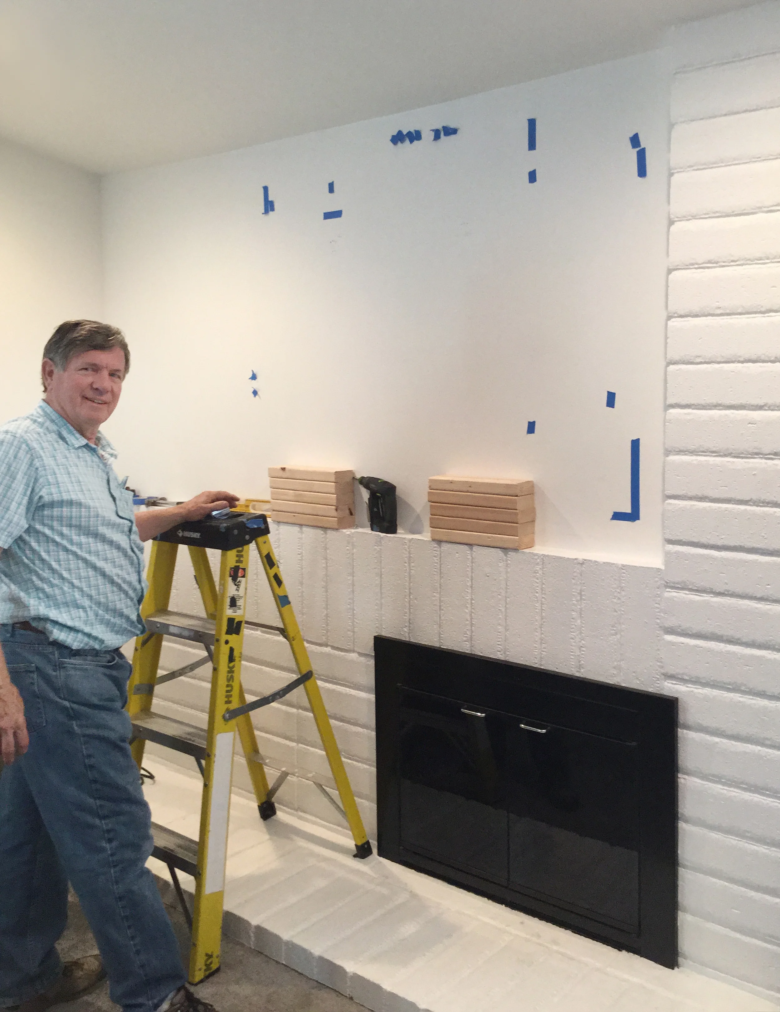 Bob finding where the joists are behind the drywall and preparing for the installation of the light box.