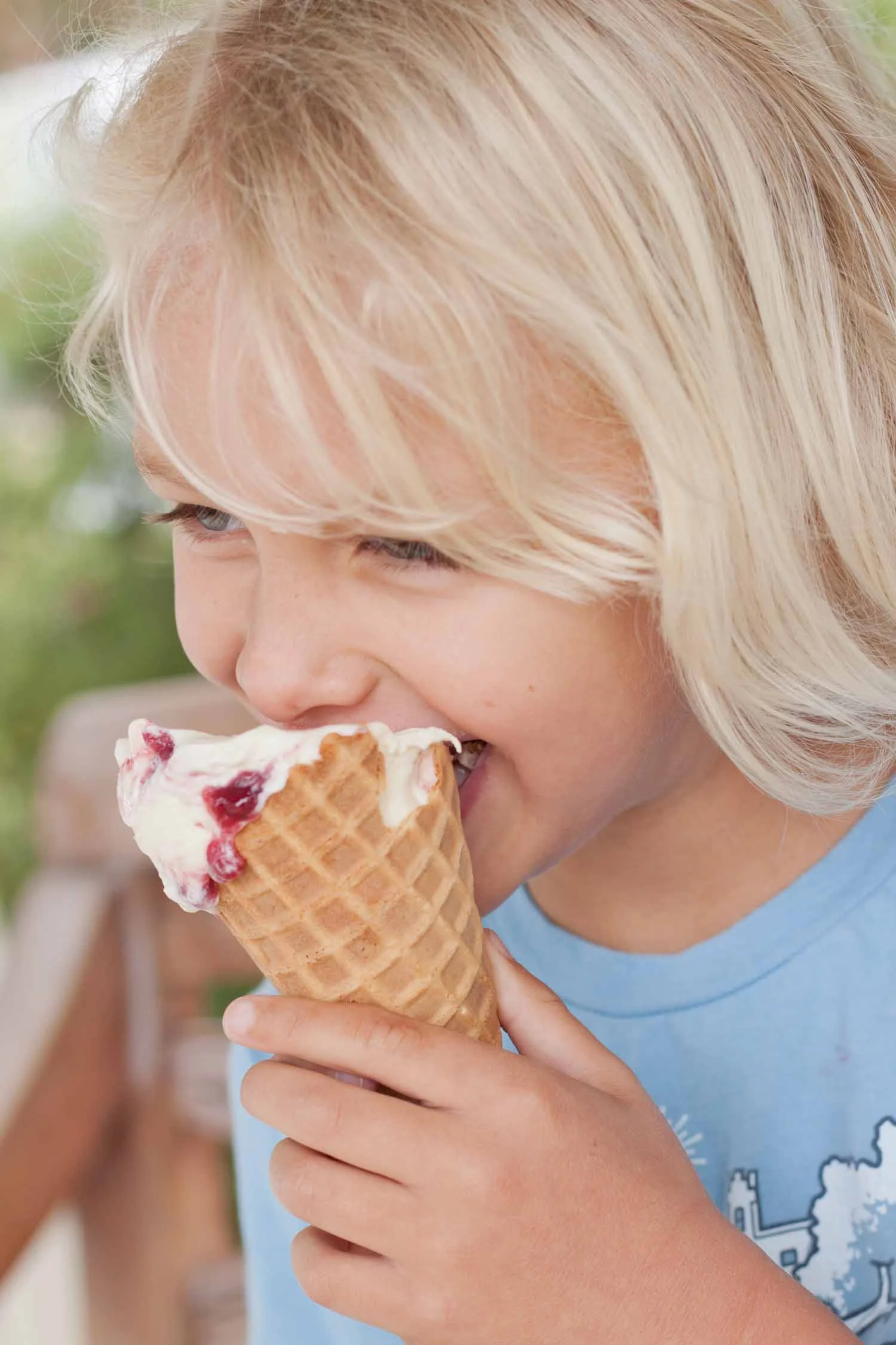 child smiling while eating an ice cream cone.jpg