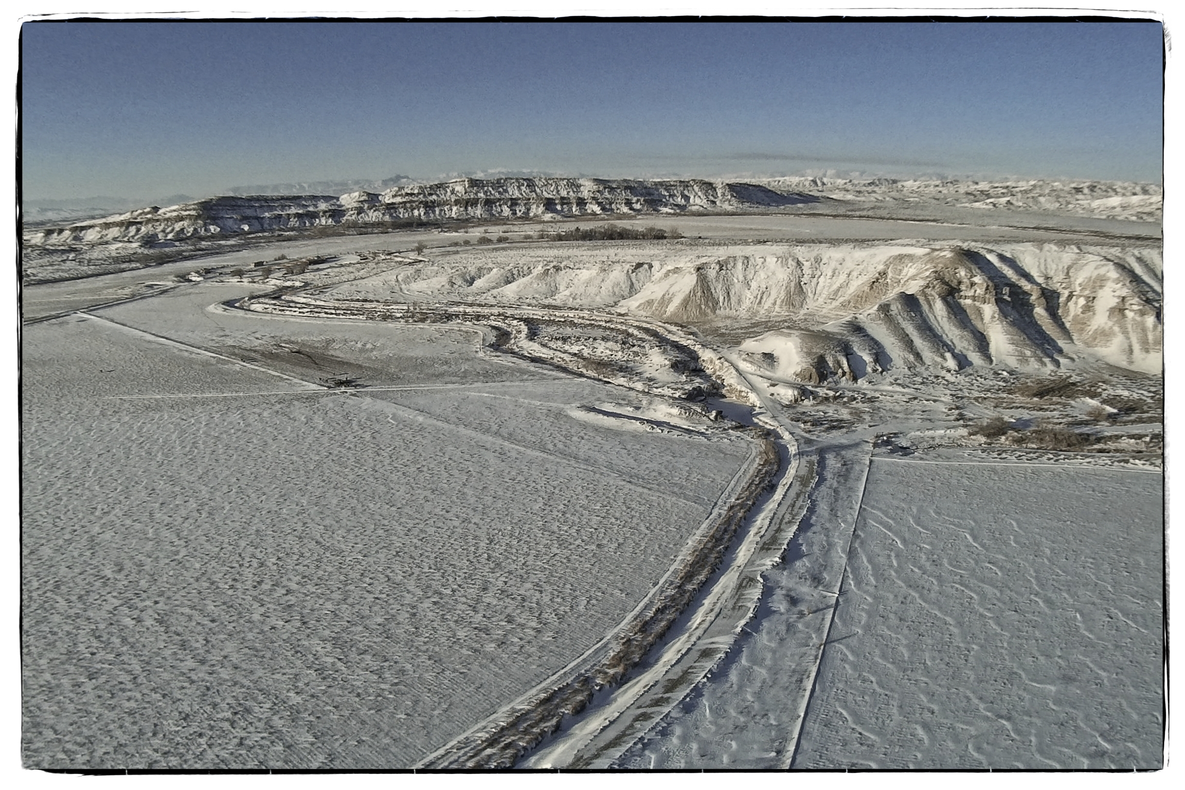 Syma X8C with a Mobius camera between Deaver and Powell, Wyoming on a sub-zero winter morning. Edited in On1 Photo 10 software.