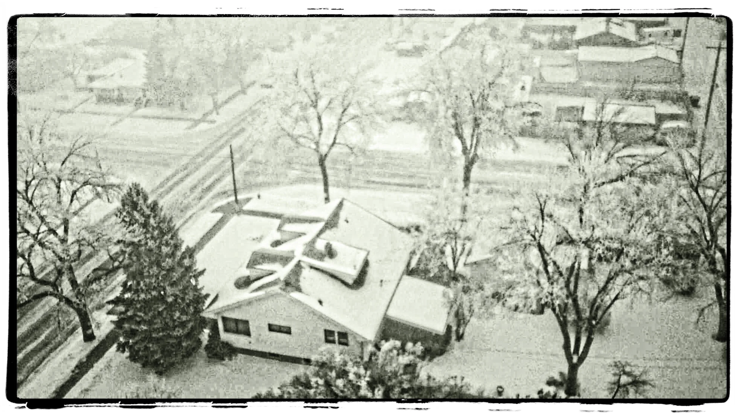 Looking down on one of the neighborhood houses with the H-12 during a snow storm.