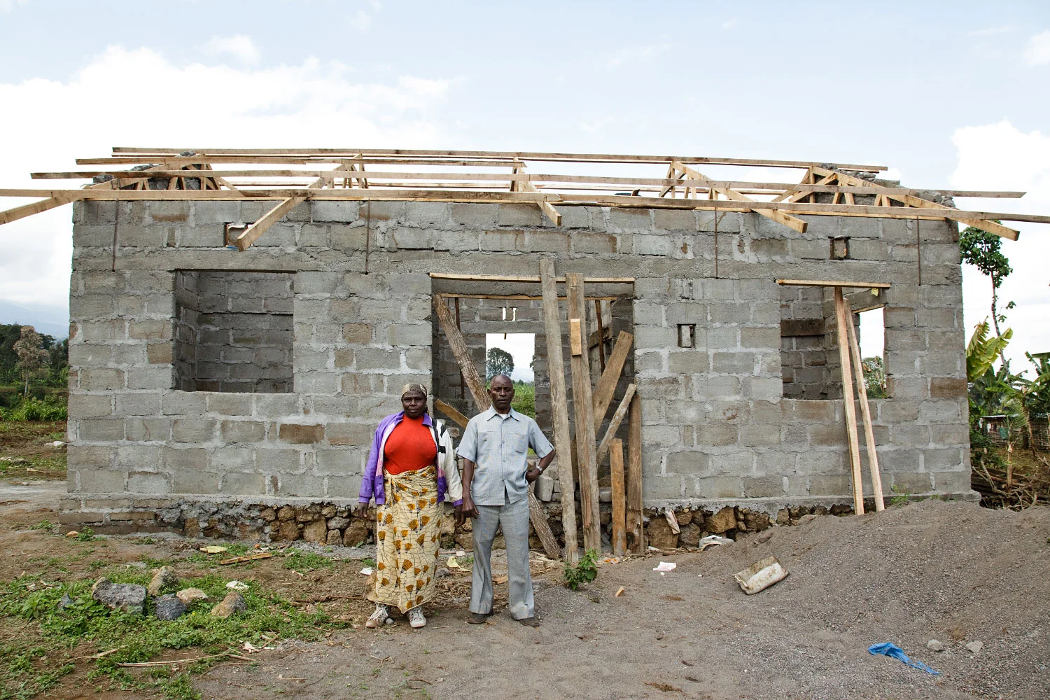 Villagers in Kibosho-Umbwe, posing proudly in front of their future house. Brick buildings are rare in the village, most people live in wooden huts.