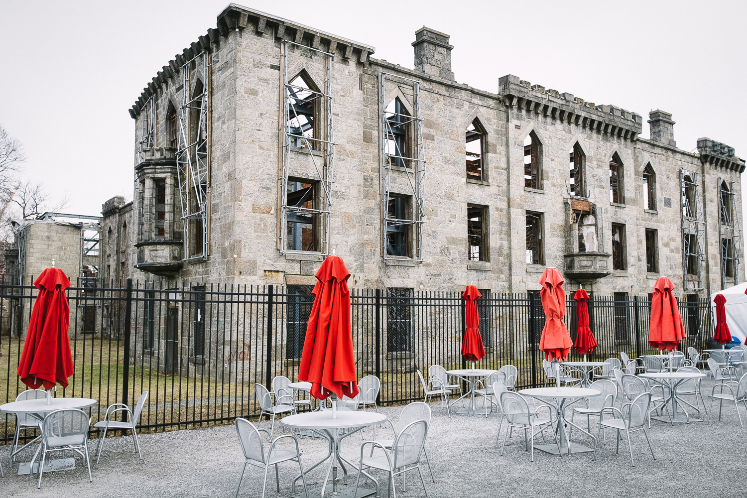 An odd combination: the ruins of a 19-century smallpox hospital and the red umbrellas from the food concession area at Southpoint Park on Roosevelt Island, New York.