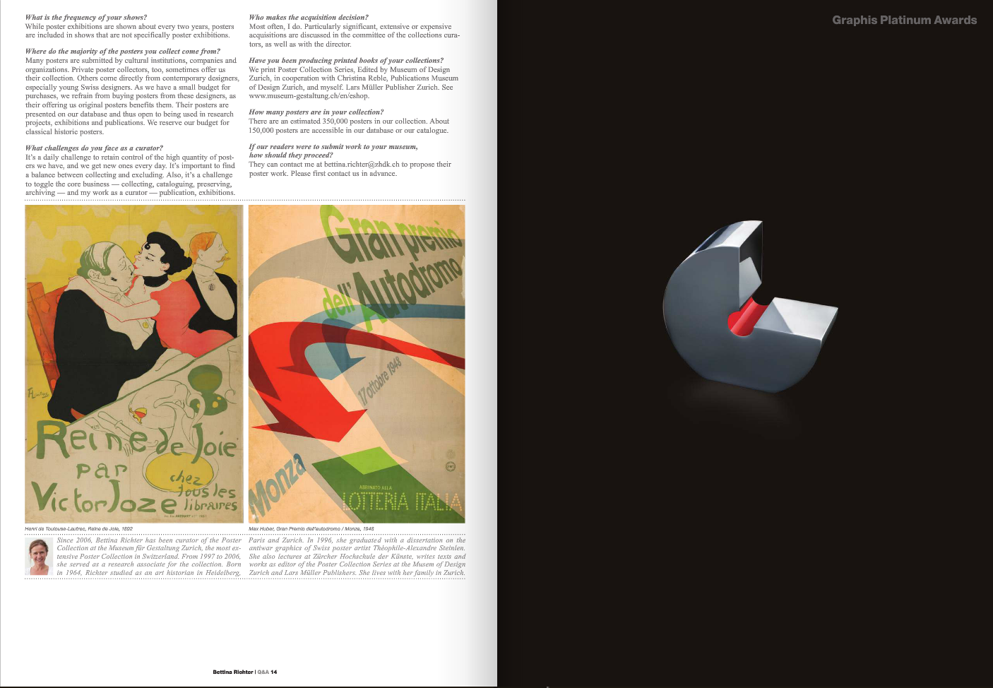 A dark background with a metallic sculpture resembling an open clamp or clip with a red handle, illuminated to highlight its metallic surface.