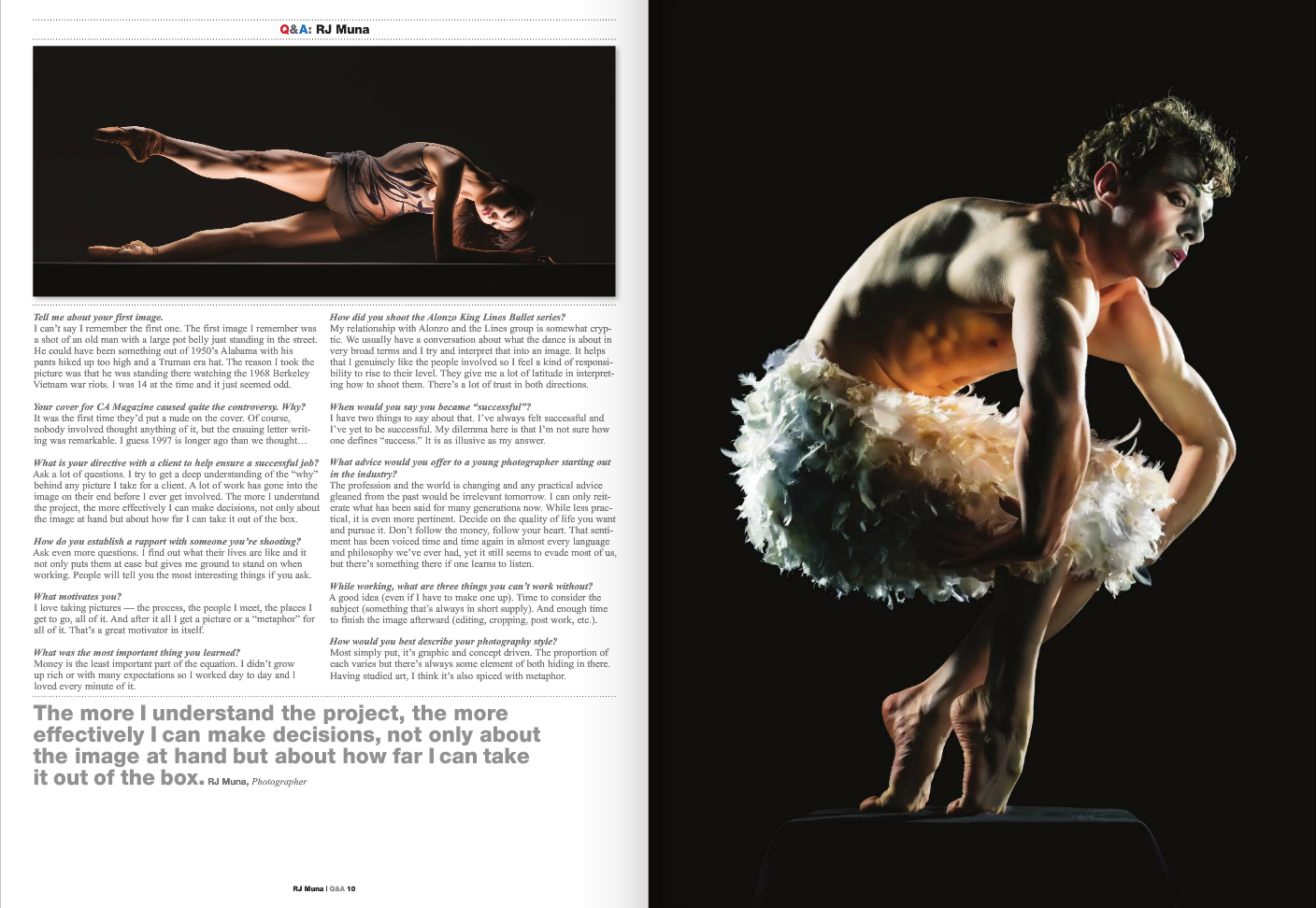 A male ballet dancer in a crouched position on a black platform, with muscular build, curly hair, and wearing a fluffy white tutu against a dark background.