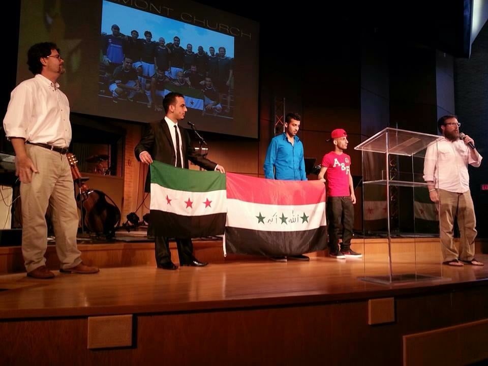 There's Saif, holding the Syrian flag and corner of the Iraqi flag with a couple of my other friends, Aws and Atheer. And the guy with the mic? That's me again with that rockin' beard!