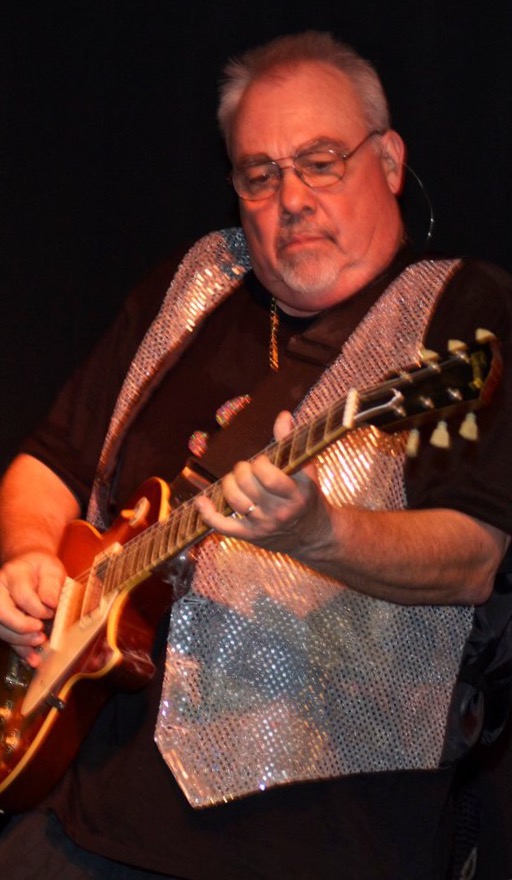 Phil rocking his guitar and a sparkly vest. I love this guy so much.