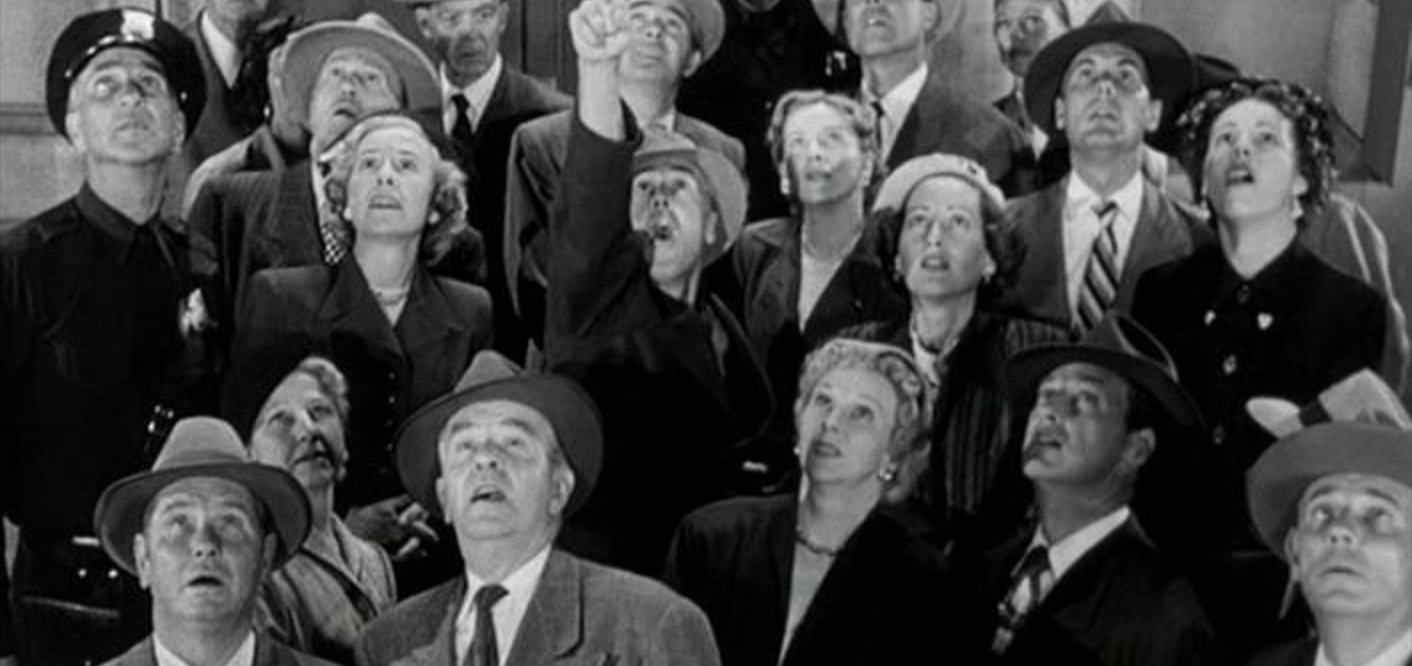 Image of a crowd of people looking up