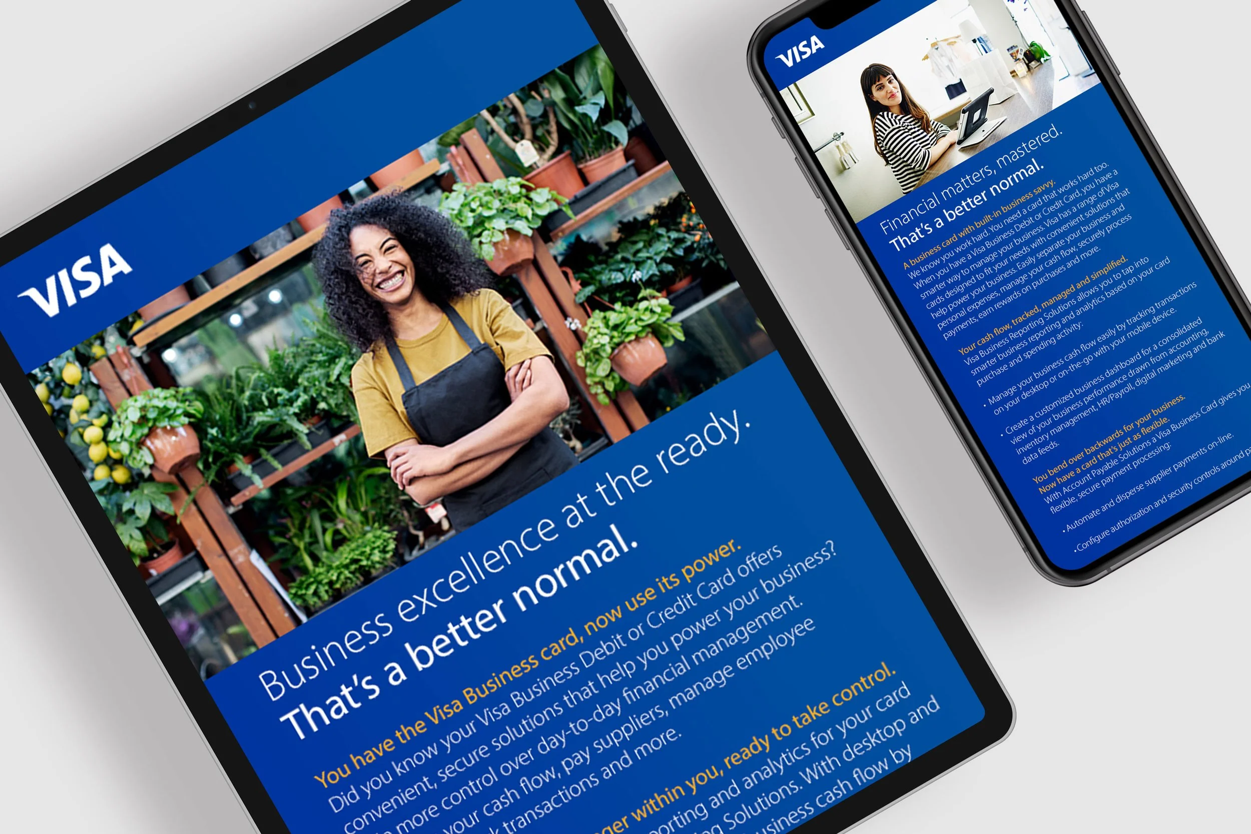 A table and smartphone displaying a Visa advertisement about business credit cards, with an image of a smiling woman in a plant shop.