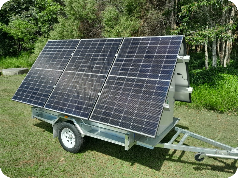 Off-grid solar trailer featuring six solar panels, outdoor inverter cabinet, and portable design for mobile power solutions.