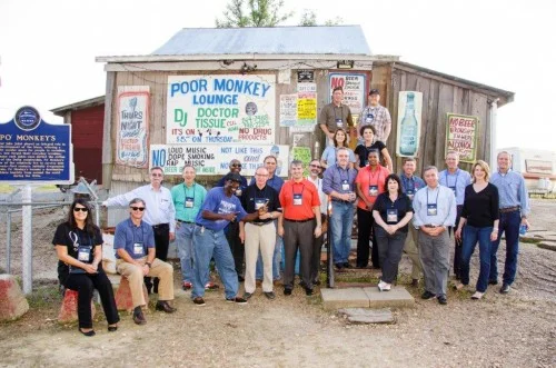 Participants in the recent Mississippi Development Authority tour of the Delta, outside Po' Monkey's Lounge in Merigold.