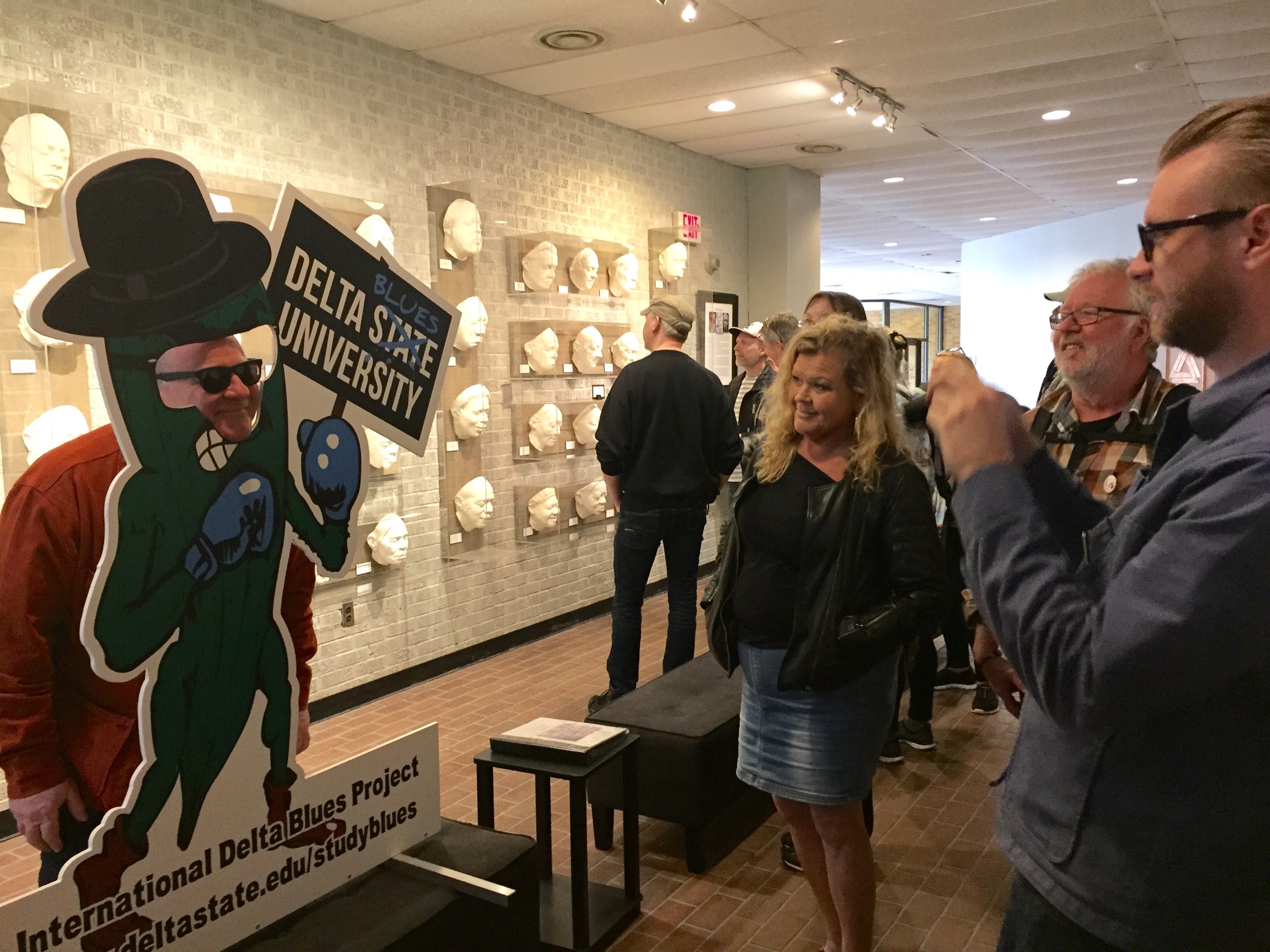  “Rock Your Blues” Swedish traveling group members enjoy a photo op with a cutout of the Delta State "Blues Okra" while viewing Sharon McConnell's Cast of Blues exhibit at The Delta Center for Culture and Learning.    