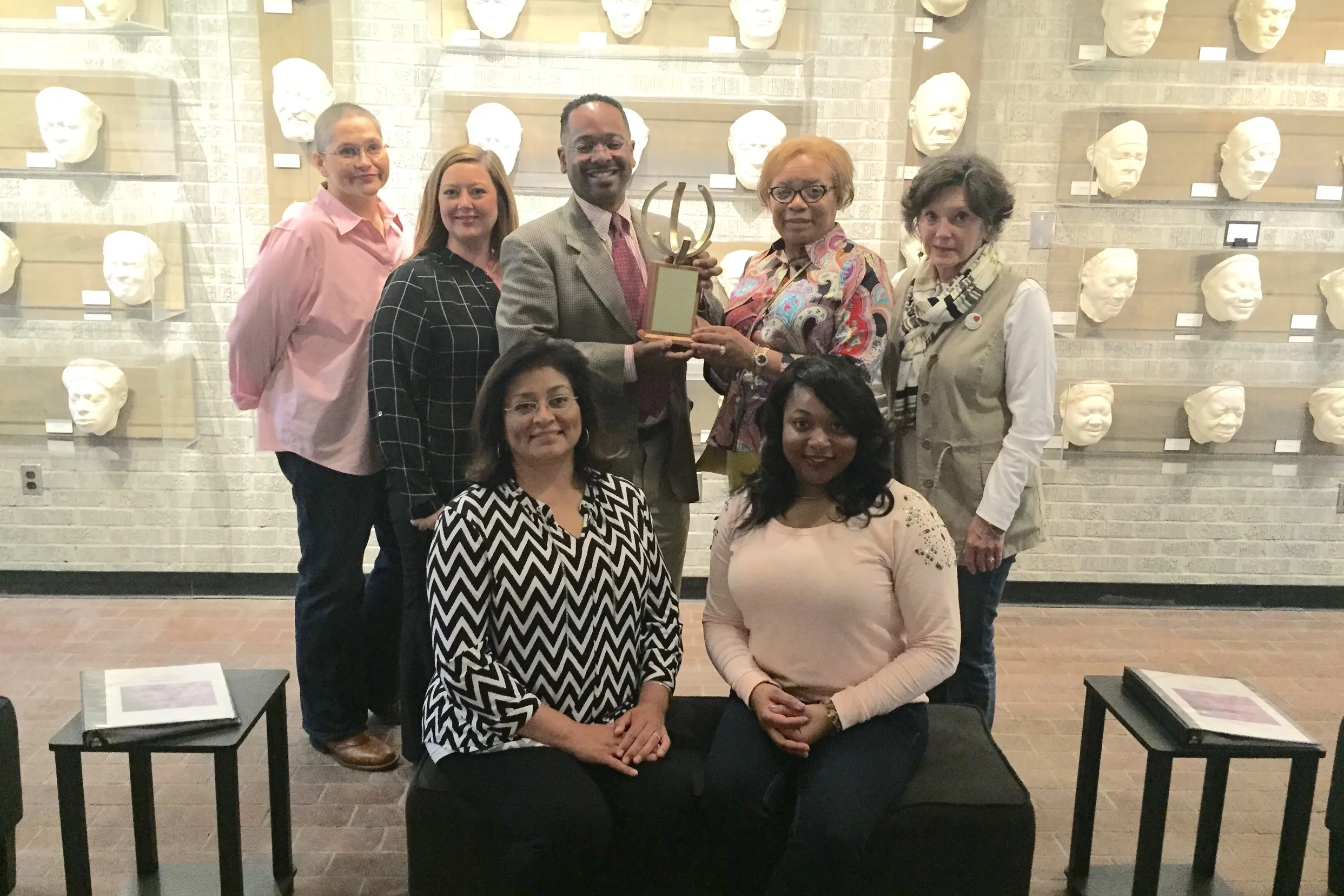 Dr. Rolando Herts receives the Georgene Clark Diversity Champion Award from Arlene Sanders, Diversity Committee chair (center) on behalf of The Delta Center, along with staff members (left to right) Patricia Webster, Heather Miller, Lee Aylward and student employees Lydia Haley and Moira Fair. Student employees not pictured include Stephanie Green and Erica Spiller.