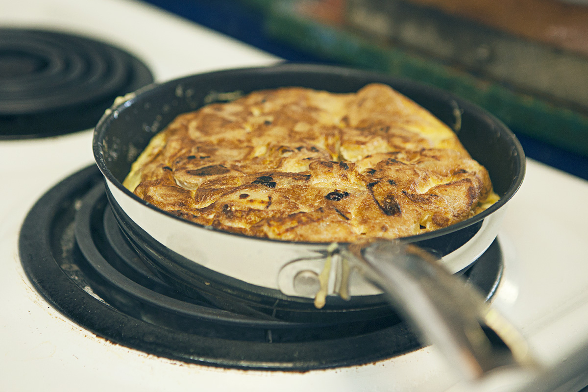 The onions have caramelized in the frying pan and the egg exterior has transformed into a crispy outer shell encapsulating the potatoes and onions.