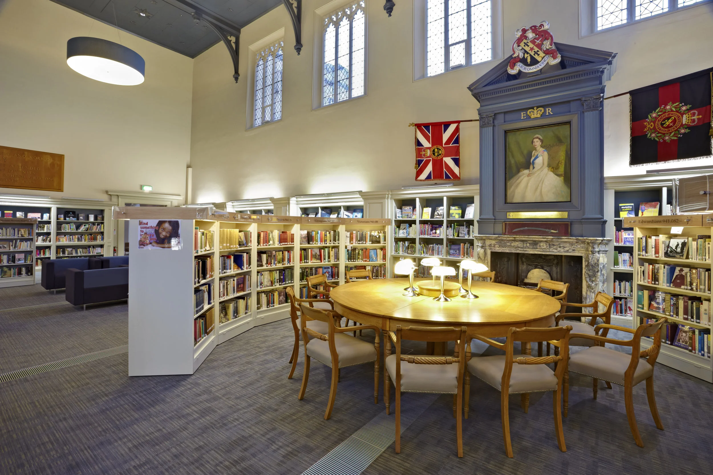 College library with bookshelves, table and seating.