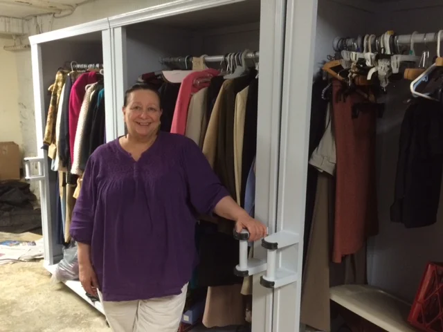 Sharon Krieger, Program Director at Samaritan Community, shows off the new custom-built closets in the newly expanded Clothing "Shop". 