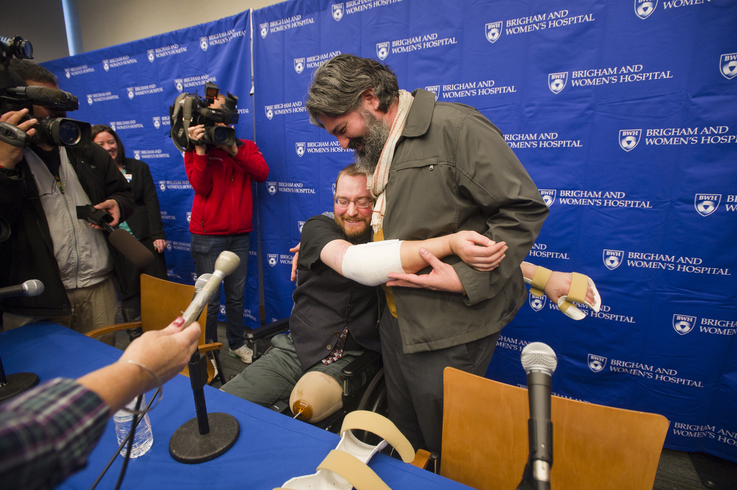  While he can't yet apply pressure to his arms, Will Lautzenheiser is still happy to demonstrate how he can now hug his partner Angle Gonzalez during a press conference to share the news of his successful bilateral arm transplant along with his surge