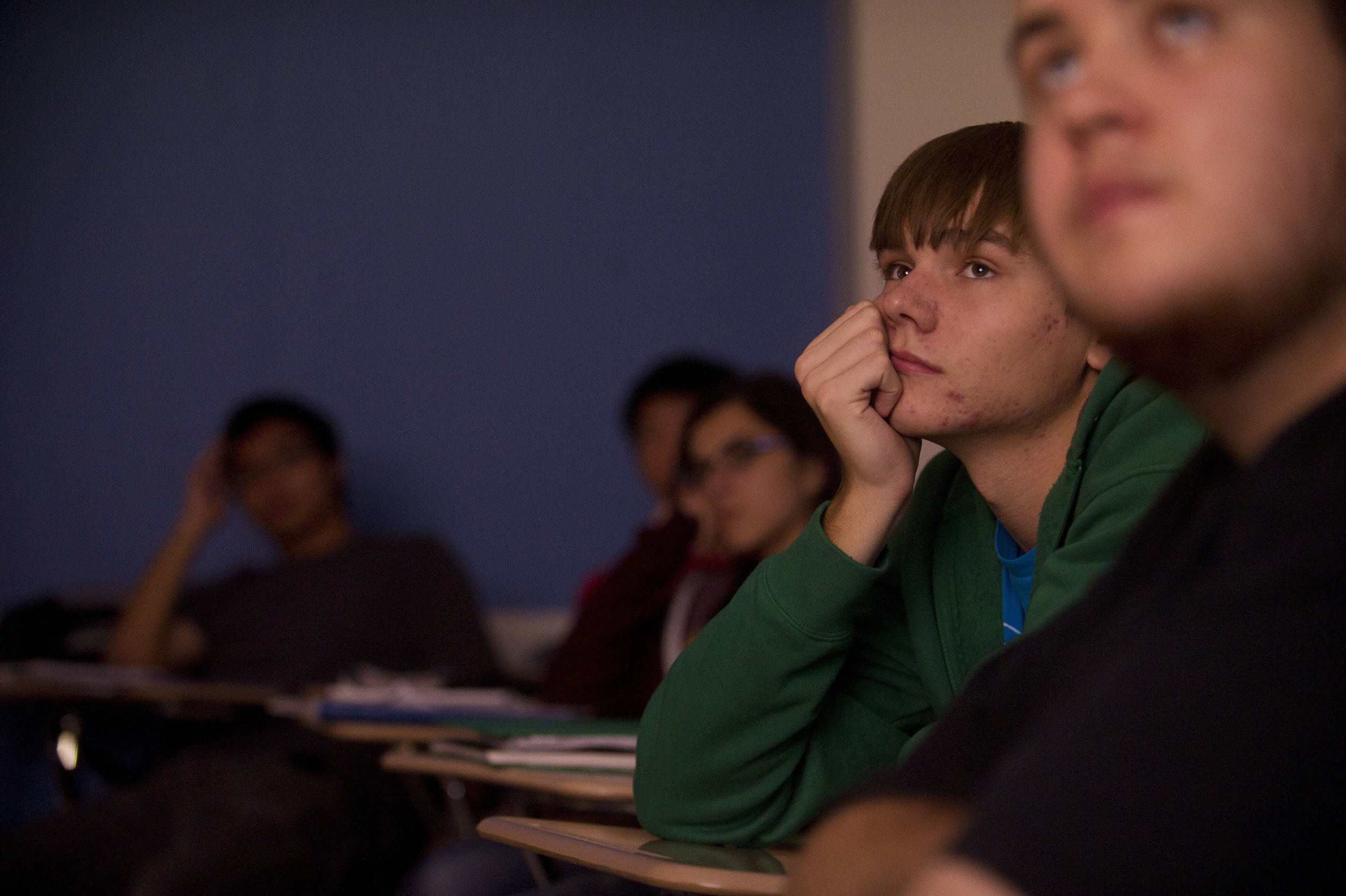  Nathan Hepler (ENG,'15) watches an episode of Battlestar Galactica during Joelle Renstrom's Evolution of Science Fiction class.&nbsp;Photo by Cydney Scott for Boston University Photography 