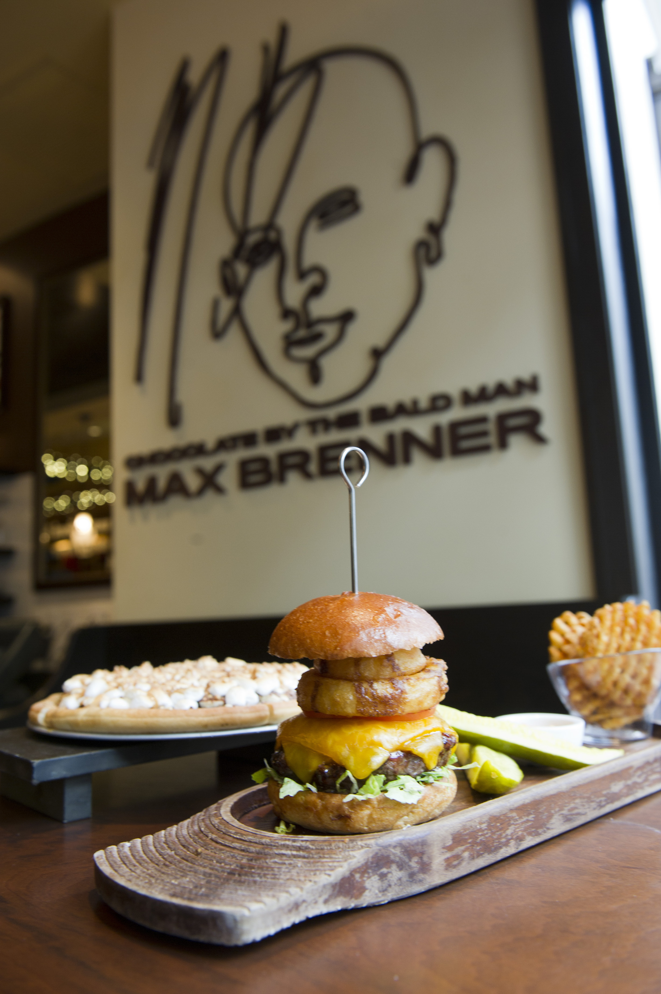  The Brenner Burger with Max's secret bbq sauce, cheddar cheese and a fried vidalia onion ring at Max Brenner's on Boylston Street November 16, 2011.&nbsp;Photo by Cydney Scott for Boston University Photography 